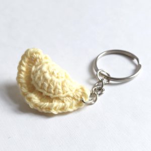a keychain with a small light yellow dumpling