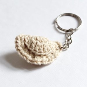 a keychain with a small beige dumpling