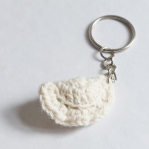 A keychain with a small dumpling, natural white